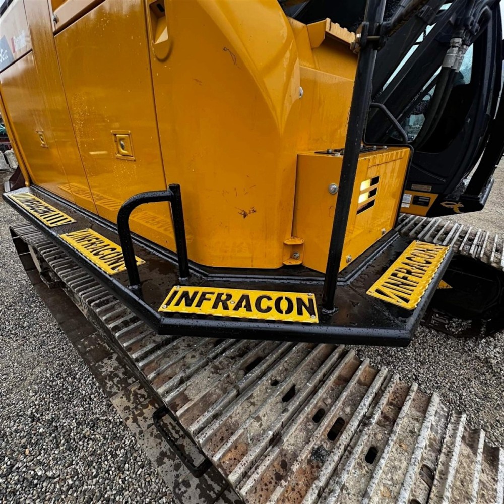 Catwalks installed on John Deere excavator with custom foot grips