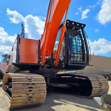 Hitachi excavator with machine body and cab guarding installed
