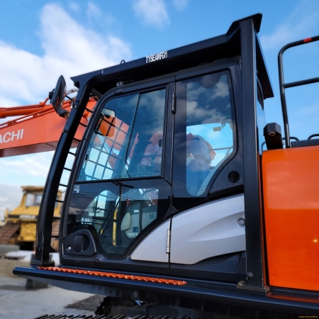 Hitachi with FOPS in shop yard